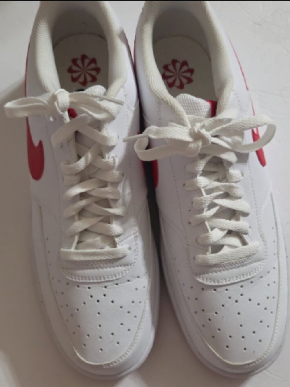 white Nikes with red bottoms